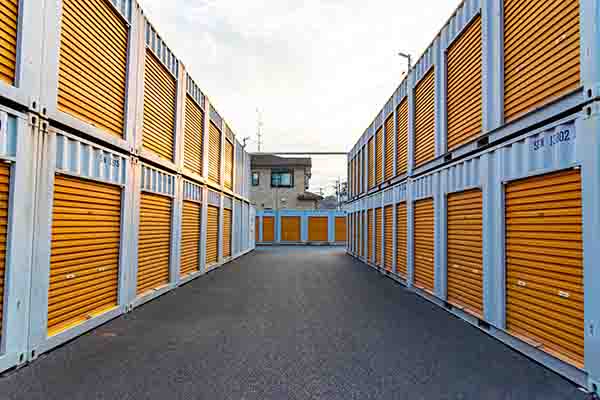 Path between two rows of storage containers to the left and right